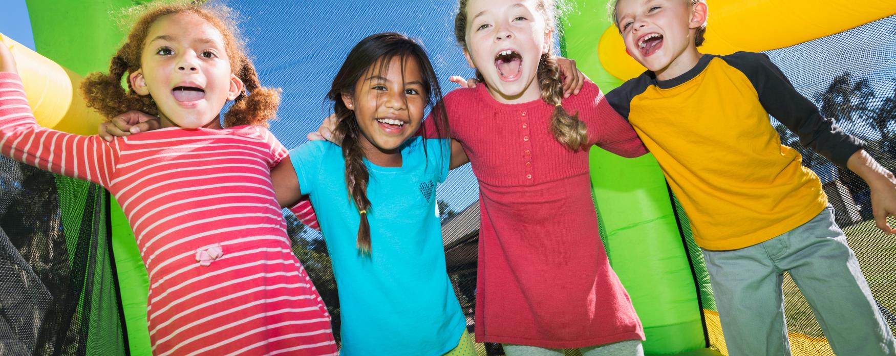 Multi-ethnic kids on bouncy castle