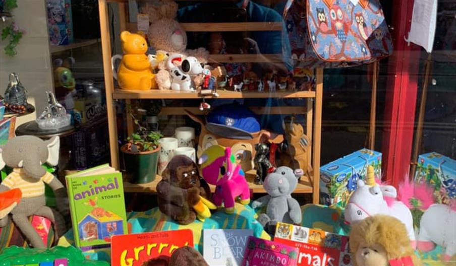 Colourful toys and children's books in the window of air ambulance charity shop