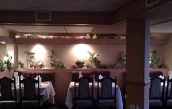 Interior of Heybridge Tandoori Indian restaurant with mood lighting and plants