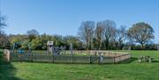 Fenced playground on field at Bell Meadow