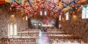 The Canary Shed wedding venue with colourful wooden birds hanging from the ceiling