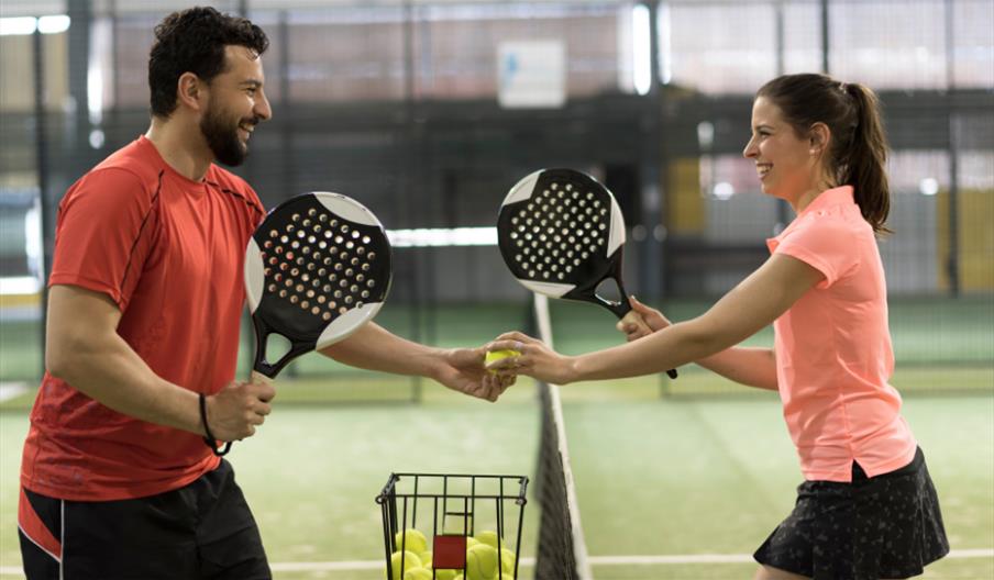 Man and woman playing Padel tennis