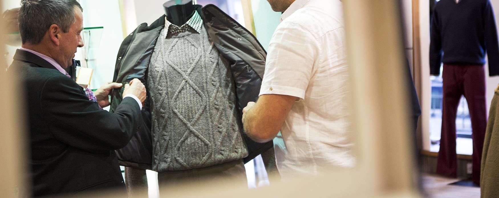Person buying suit in mirror