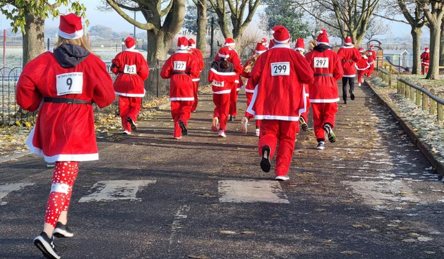 Back view of runners in the Santa Fun Run