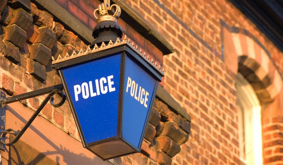 An illuminated blue police lamp