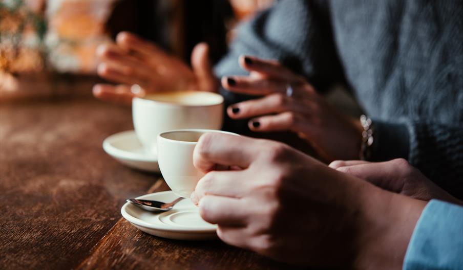 People drinking tea and coffee together