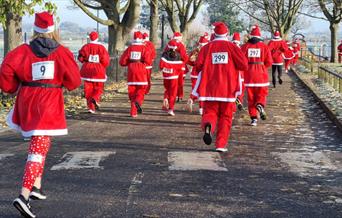 Back view of runners in the Santa Fun Run