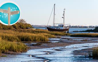 Red boat moored in the creek at Goldhanger, by James Crisp