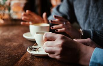 People drinking tea and coffee together