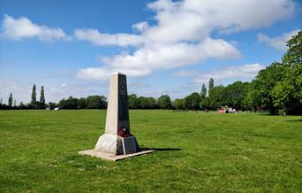 The stone memorial is a simple white obelisk on the playing fields