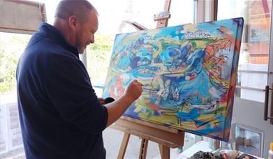 Artist Ken Flower at work in the gallery