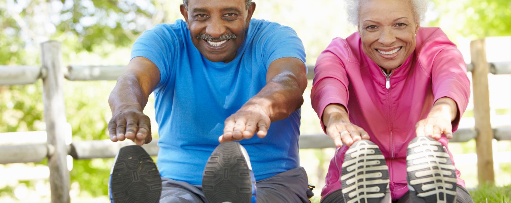Older couple exercising in park