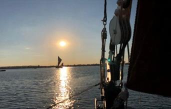 Sunset on the river with Topsail Charters