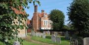 Woodham Mortimer Hall's distinctive chimneys, glimpsed from St Margaret's Church