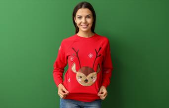 Woman wearing Christmas jumper with reindeer on