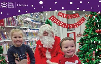Children sitting in the library with Santa