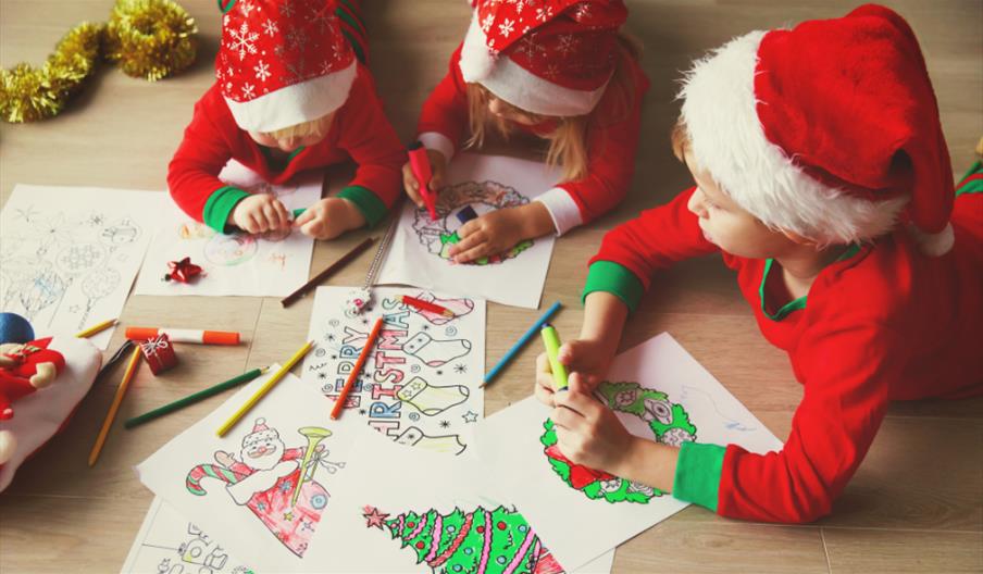 children in Santa hats doing crafts