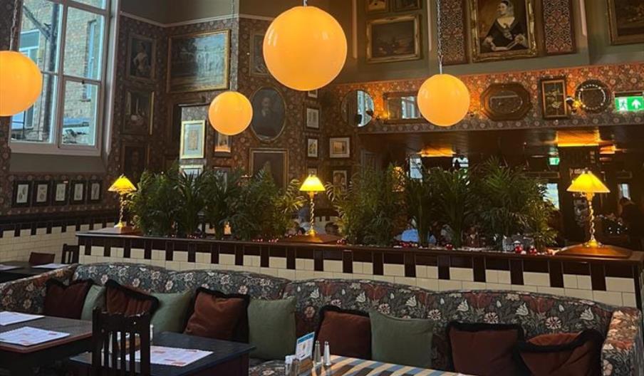 Inside Maldon Salero Lounge with paintings, globe lights and tiling