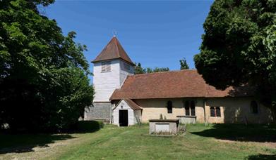 Exterior of All Saints' Church in Little Totham with white weatherboarded tower