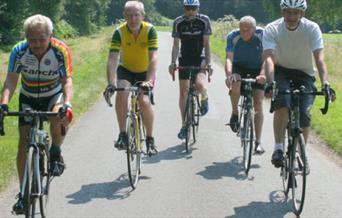 Group of five older men on road bikes