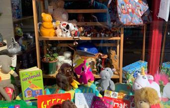 Colourful toys and children's books in the window of air ambulance charity shop