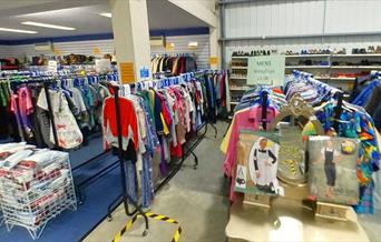 Charity shop warehouse with huge selection of clothing and shoes