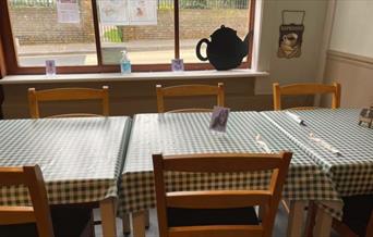 cafe tables and chairs laid with gingham cloths at Newman's