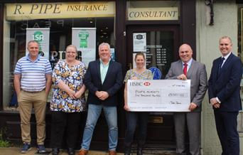 Cheque being presented to Plume School by Roy Pipe Insurance