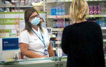 Pharmacist offering healthcare advice in Tesco