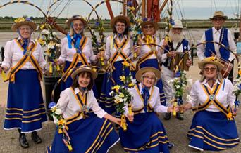 Alive and Kicking Morris Dancing side in blue and yellow costumes