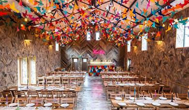 The Canary Shed wedding venue with colourful wooden birds hanging from the ceiling