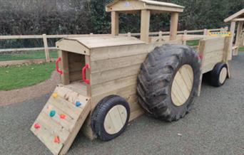 Wooden tractor for imaginative play at Great Braxted playground, made by Playsafe Playgrounds