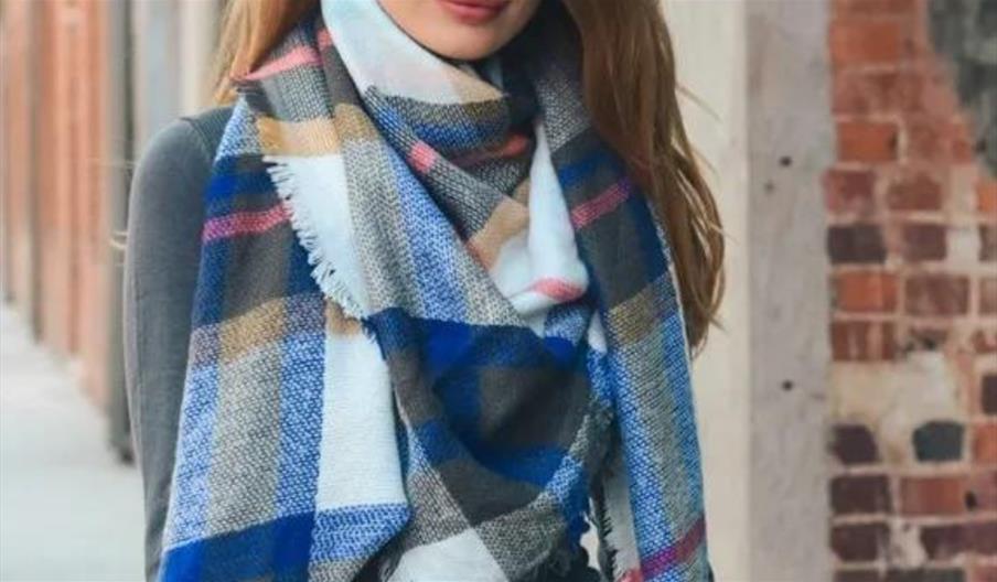 Woman modelling plaid scarf from Lewis Fashion