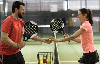 Man and woman playing Padel tennis