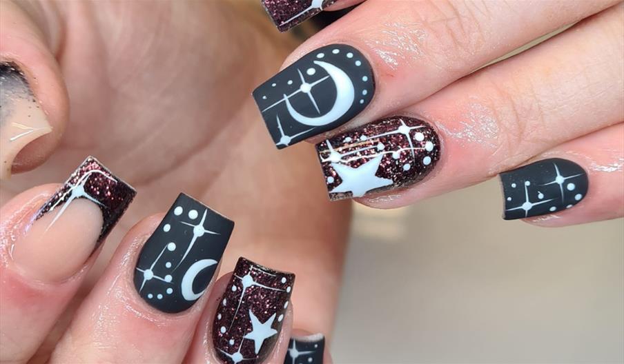Nail art by Queen's Salon with black and white moon and stars motif