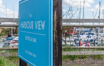 Blue sign for Harbour View in front of the marina