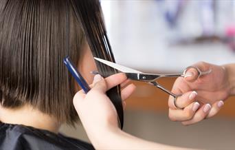Woman having her hair cut