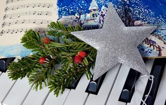 Christmas star on piano keyboard