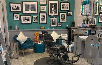 Johns Salon barber shop with grey decor and art work