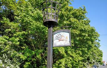 Mundon Village Sign with the beacon above it