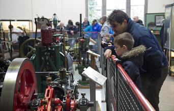 Man and boy looking at equipment at the Museum of Power