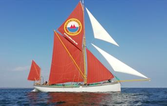 A thames barge of the Sea-Change Sailing Trust on the waves.