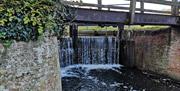 The lock gates closed with water cascading over them.
