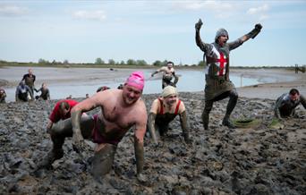 A group of racers crawling through the mud