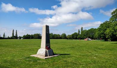 The stone memorial is a simple white obelisk on the playing fields